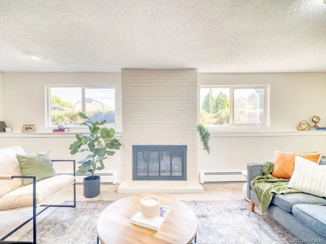 a living room with furniture and a potted plant