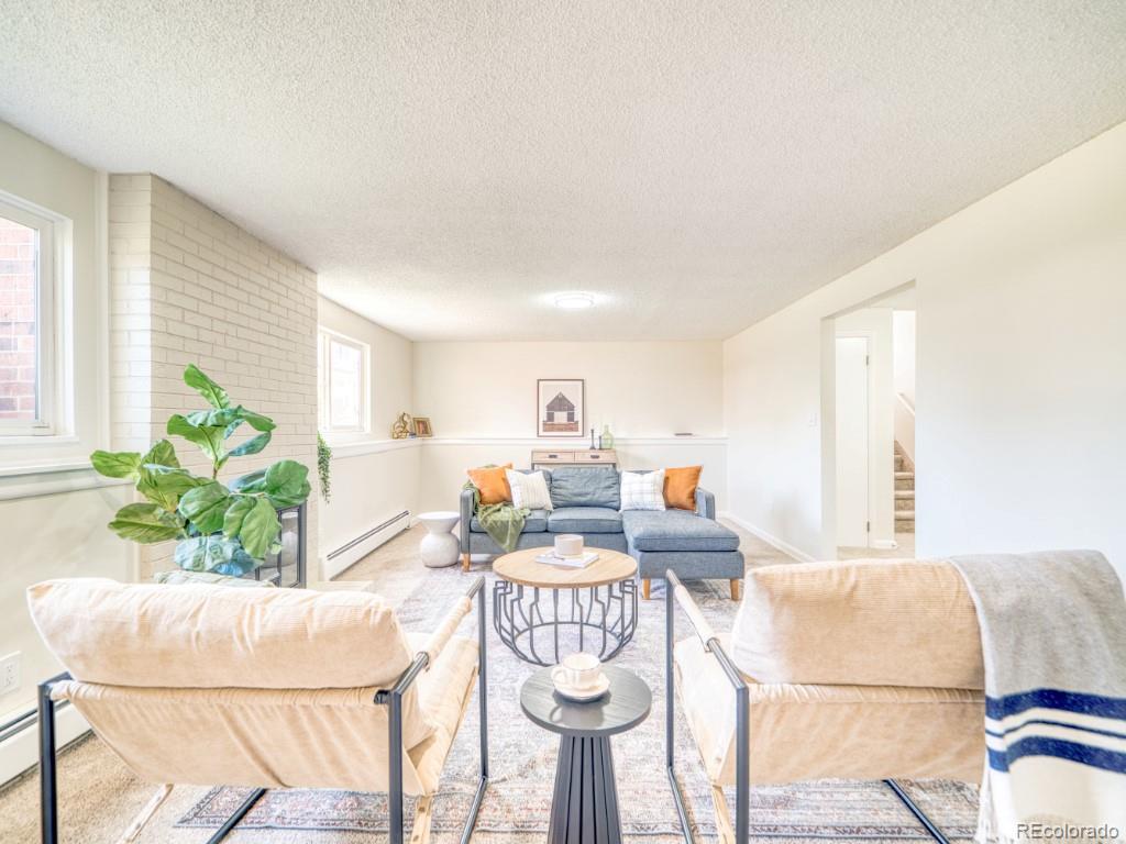2730 West Mississippi Avenue, Unit 8 Denver, CO 80219 - Photo 17 of 40 a living room with furniture and a table