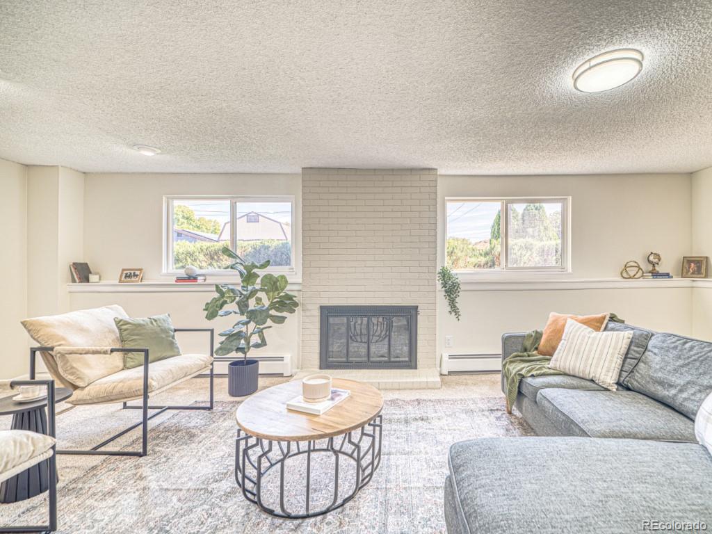 2730 West Mississippi Avenue, Unit 8 Denver, CO 80219 - Photo 19 of 40 a living room with furniture and a fireplace