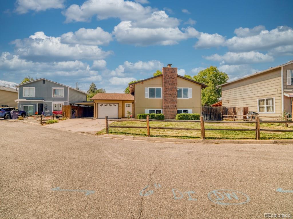 2730 West Mississippi Avenue, Unit 8 Denver, CO 80219 - Photo 2 of 40 a view of a house with a big yard and large trees