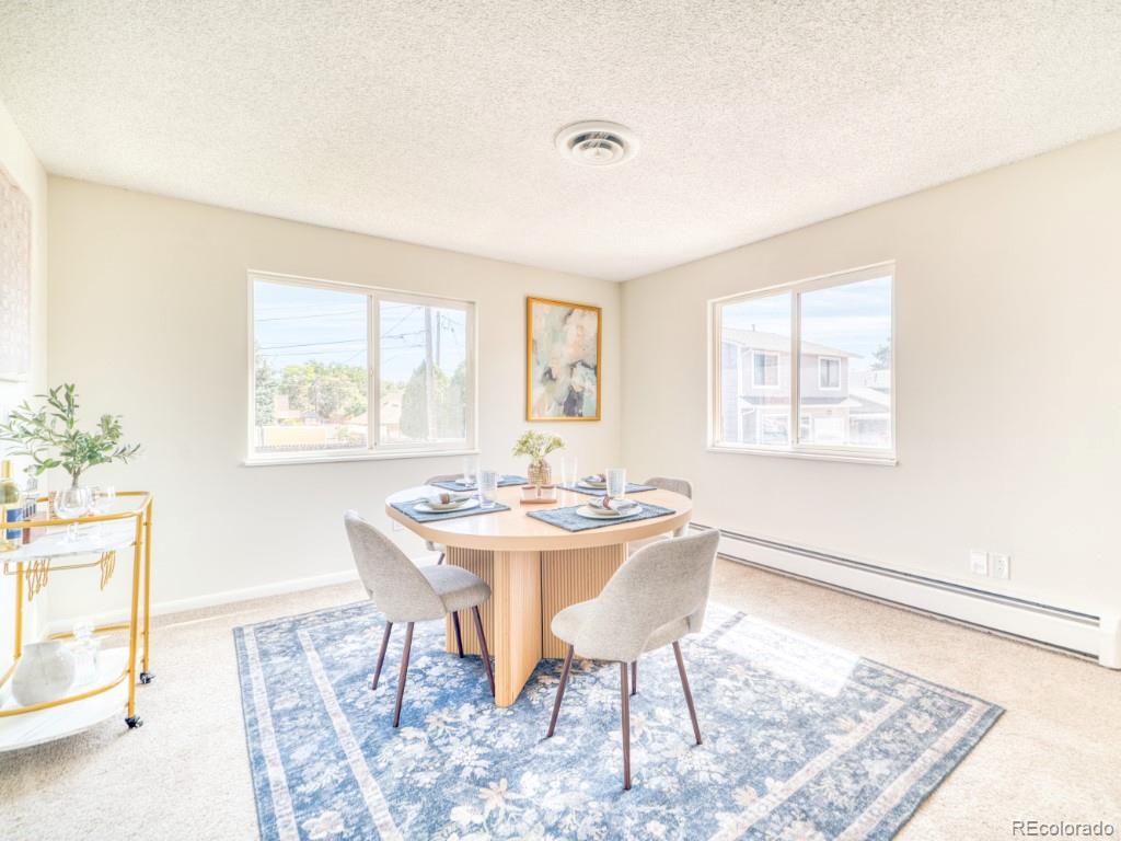 2730 West Mississippi Avenue, Unit 8 Denver, CO 80219 - Photo 23 of 40 a view of a dining room with furniture window and wooden floor