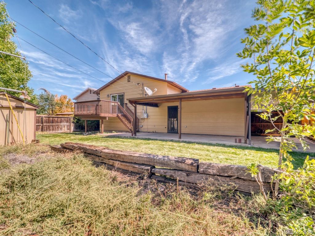 2730 West Mississippi Avenue, Unit 8 Denver, CO 80219 - Photo 35 of 40 a front view of a house with a yard