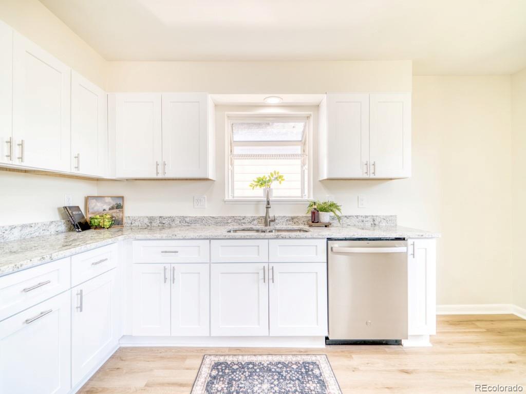 2730 West Mississippi Avenue, Unit 8 Denver, CO 80219 - Photo 4 of 40 a kitchen with stainless steel appliances granite countertop a sink stove and cabinets