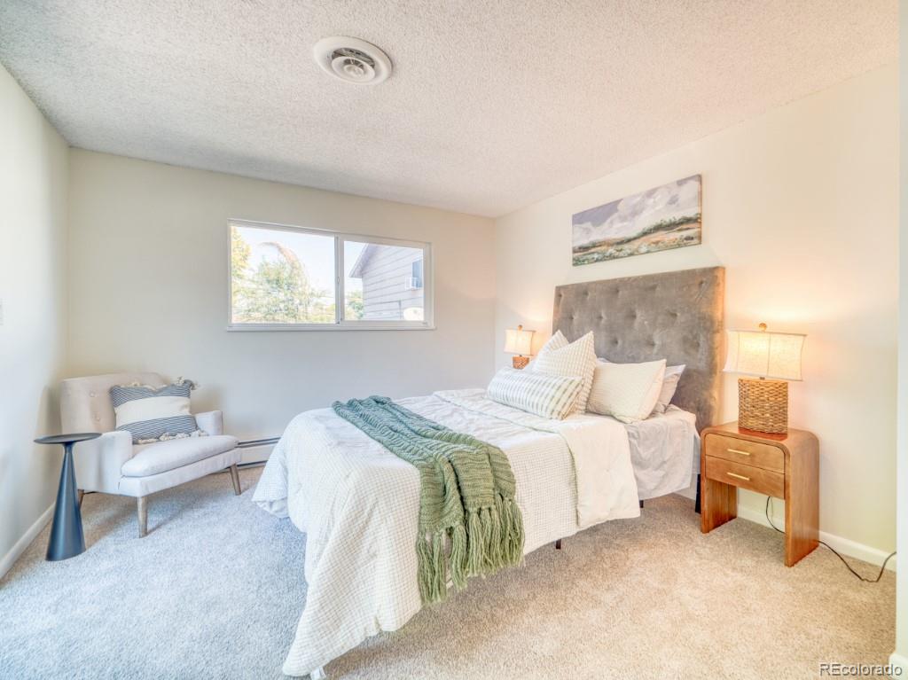 2730 West Mississippi Avenue, Unit 8 Denver, CO 80219 - Photo 9 of 40 a bedroom with a bed and a window