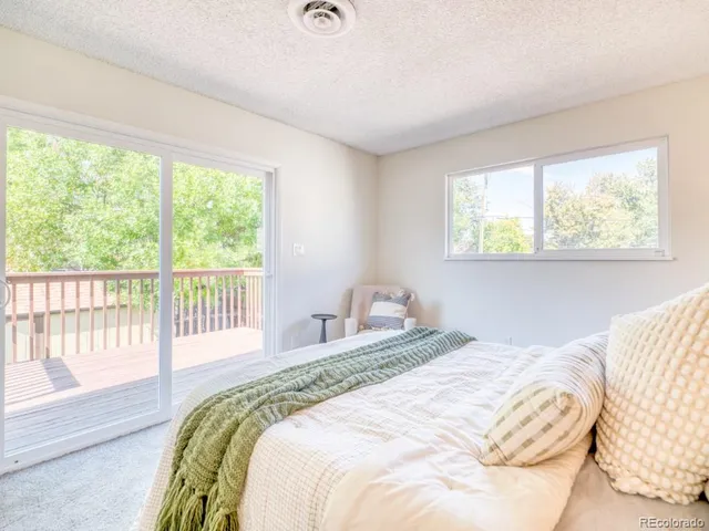 a bedroom with a bed and a large window