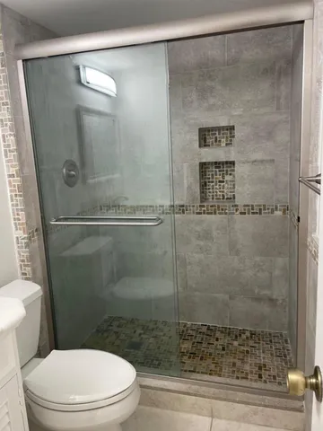 a bathroom with a shower and a toilet