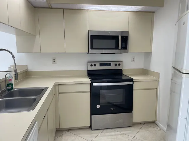 a kitchen with a sink and a stove top oven
