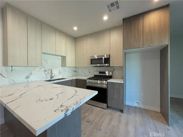 a kitchen with a sink a stove and refrigerator