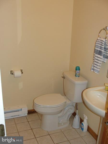 108 Reynolds Road Albrightsville, PA 18210 - Photo 11 of 16 a white toilet sitting next to a bathroom sink and vanity