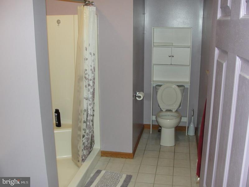 108 Reynolds Road Albrightsville, PA 18210 - Photo 10 of 16 a white toilet sitting next to a bathroom sink
