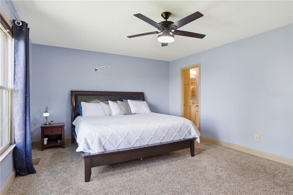 3326 Monument Road Jasper, GA 30143 - Photo 17 of 49 a bedroom with a bed and a chandelier