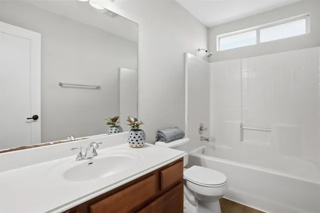 a bathroom with a sink toilet tub and shower