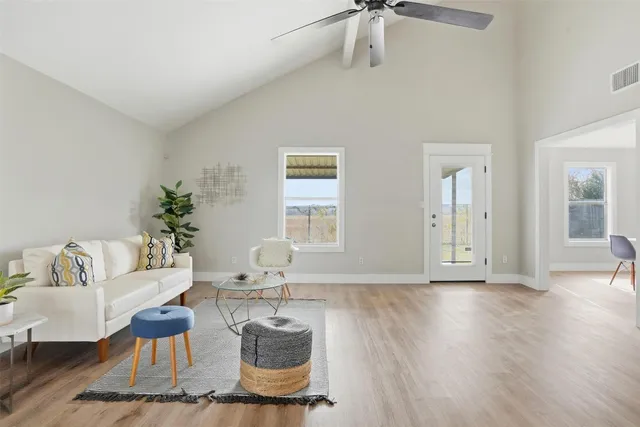 a living room with furniture and wooden floor