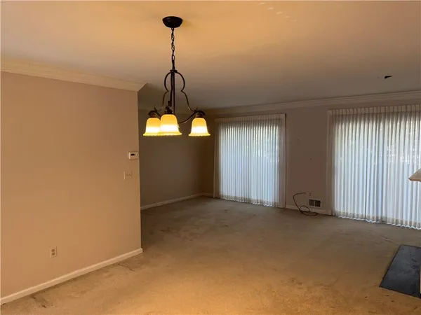 a view of a room with a ceiling fan