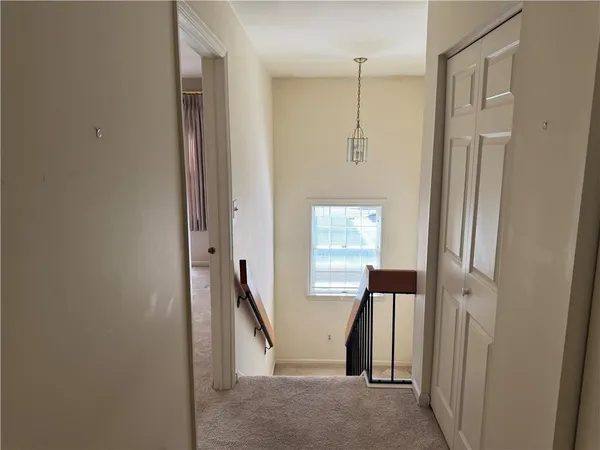 a view of a hallway with wooden floor and entryway