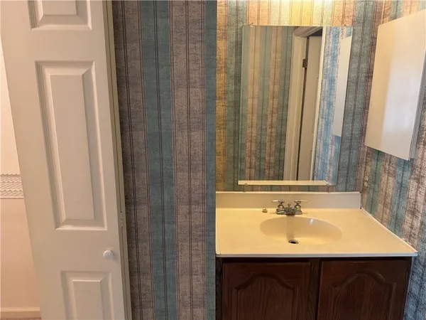 a bathroom with a sink a mirror and a shower