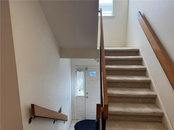 a view of entryway and gallery with wooden floor