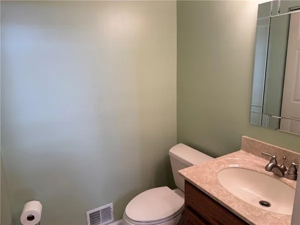 a bathroom with a sink a toilet and mirror