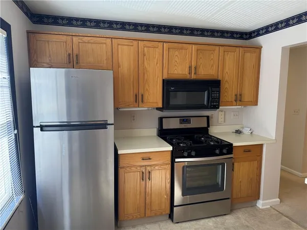 a kitchen with a stove a microwave and a refrigerator