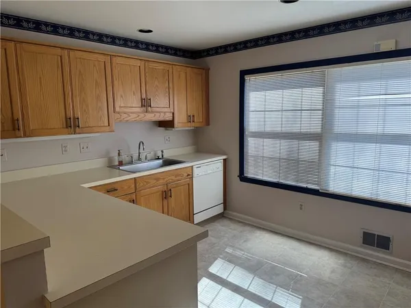 a kitchen with a cabinets and white appliances
