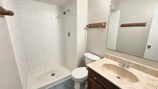a bathroom with a sink toilet and shower