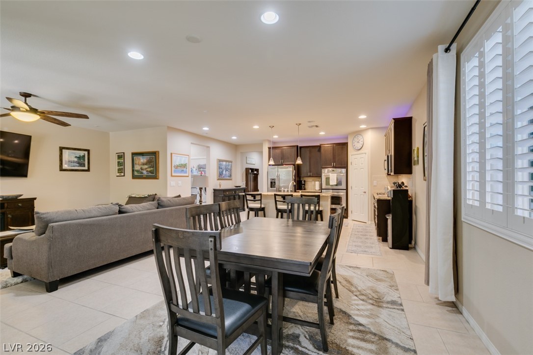 7375 Campbell Ranch Avenue Las Vegas, NV 89179 - Photo 44 of 45 An open floorplan seamlessly connects the living and dining areas to a well-appointed kitchen.