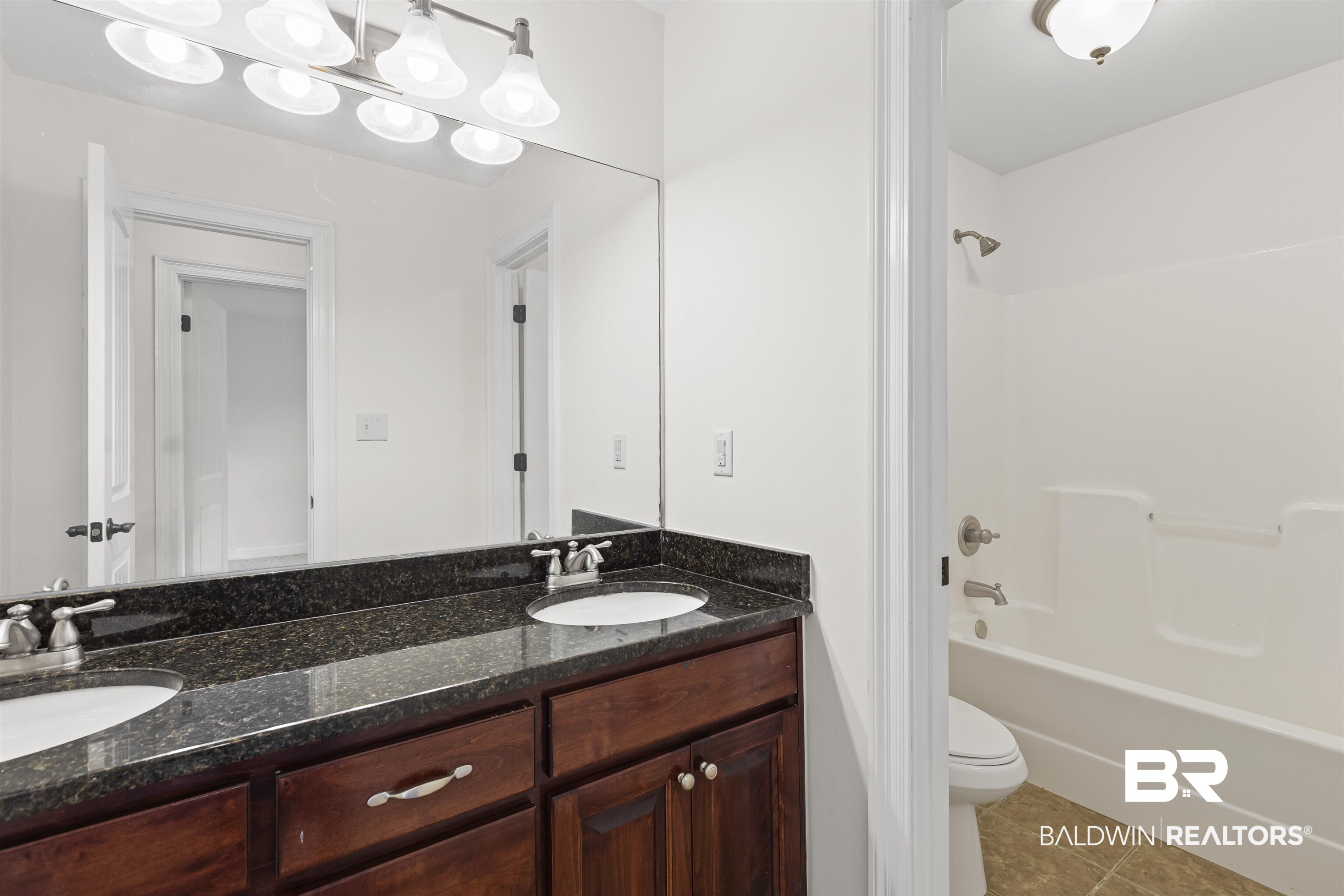 924 Brady Road North Bay Minette, AL 36507 - Photo 19 of 26 Full bathroom with tile patterned floors, double vanity, and bathing tub / shower combination