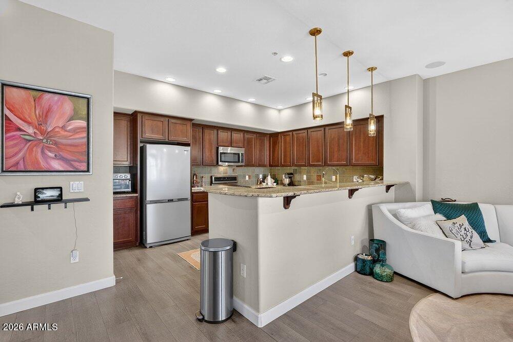 4777 South Fulton Ranch Boulevard, Unit 2035 Chandler, AZ 85248 - Photo 13 of 51 a kitchen with kitchen island a refrigerator sink and stove