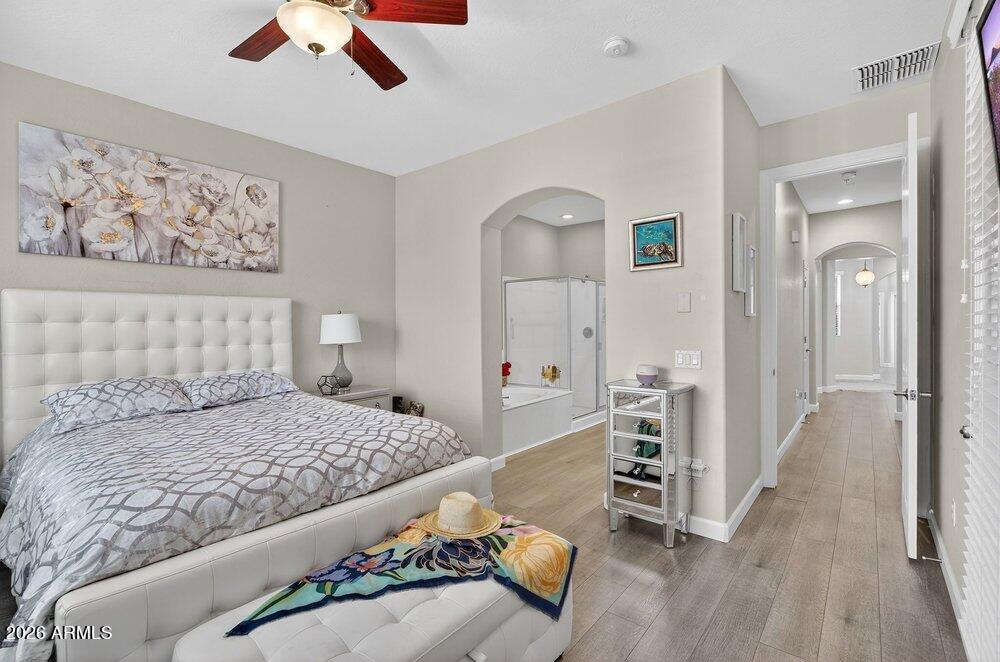 4777 South Fulton Ranch Boulevard, Unit 2035 Chandler, AZ 85248 - Photo 21 of 51 a bedroom with a bed and a chandelier