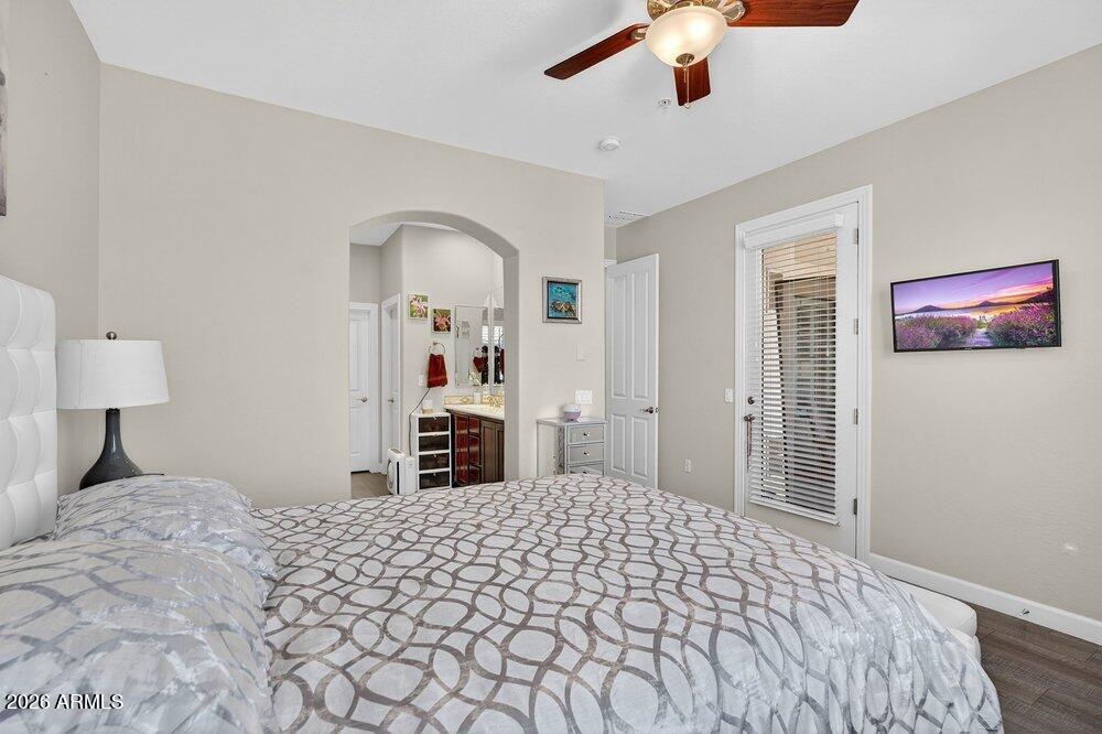 4777 South Fulton Ranch Boulevard, Unit 2035 Chandler, AZ 85248 - Photo 22 of 51 a bedroom with a large bed and a chandelier
