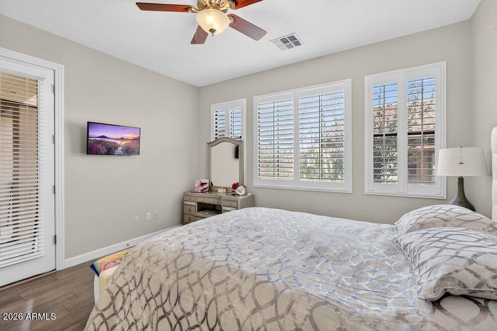 4777 South Fulton Ranch Boulevard, Unit 2035 Chandler, AZ 85248 - Photo 23 of 51 a bedroom with a bed and a chandelier