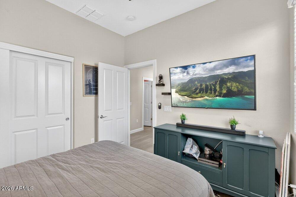4777 South Fulton Ranch Boulevard, Unit 2035 Chandler, AZ 85248 - Photo 28 of 51 a bedroom with a bed and a flat screen tv