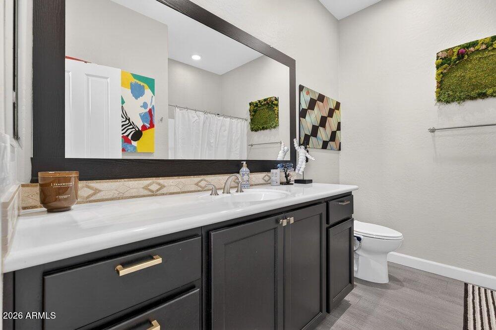 4777 South Fulton Ranch Boulevard, Unit 2035 Chandler, AZ 85248 - Photo 29 of 51 a bathroom with a sink mirror and toilet