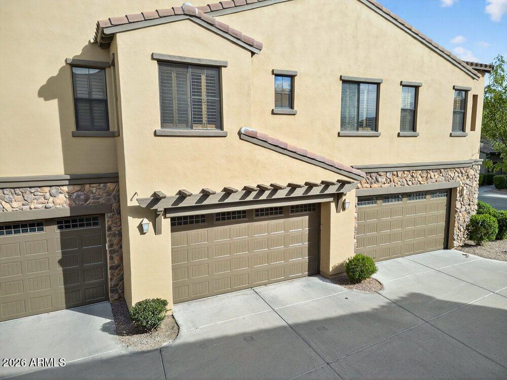 4777 South Fulton Ranch Boulevard, Unit 2035 Chandler, AZ 85248 - Photo 35 of 51 a front view of a house with garage