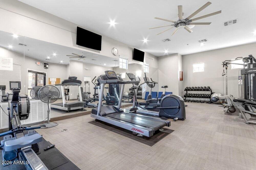 4777 South Fulton Ranch Boulevard, Unit 2035 Chandler, AZ 85248 - Photo 48 of 51 a living room with gym equipment and a flat screen tv