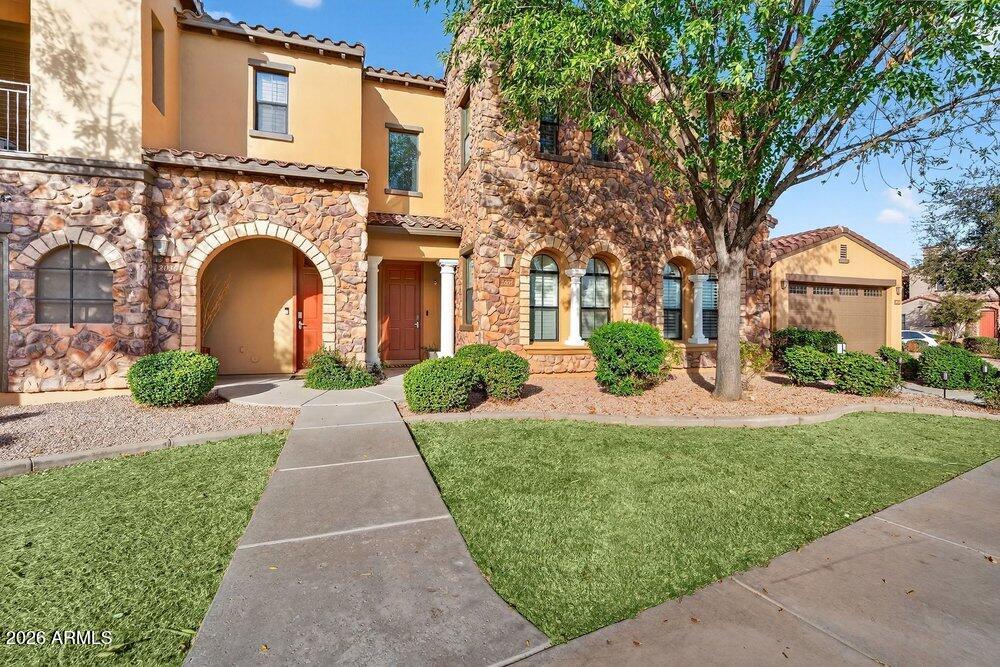 4777 South Fulton Ranch Boulevard, Unit 2035 Chandler, AZ 85248 - Photo 5 of 51 a front view of a house with garden and trees