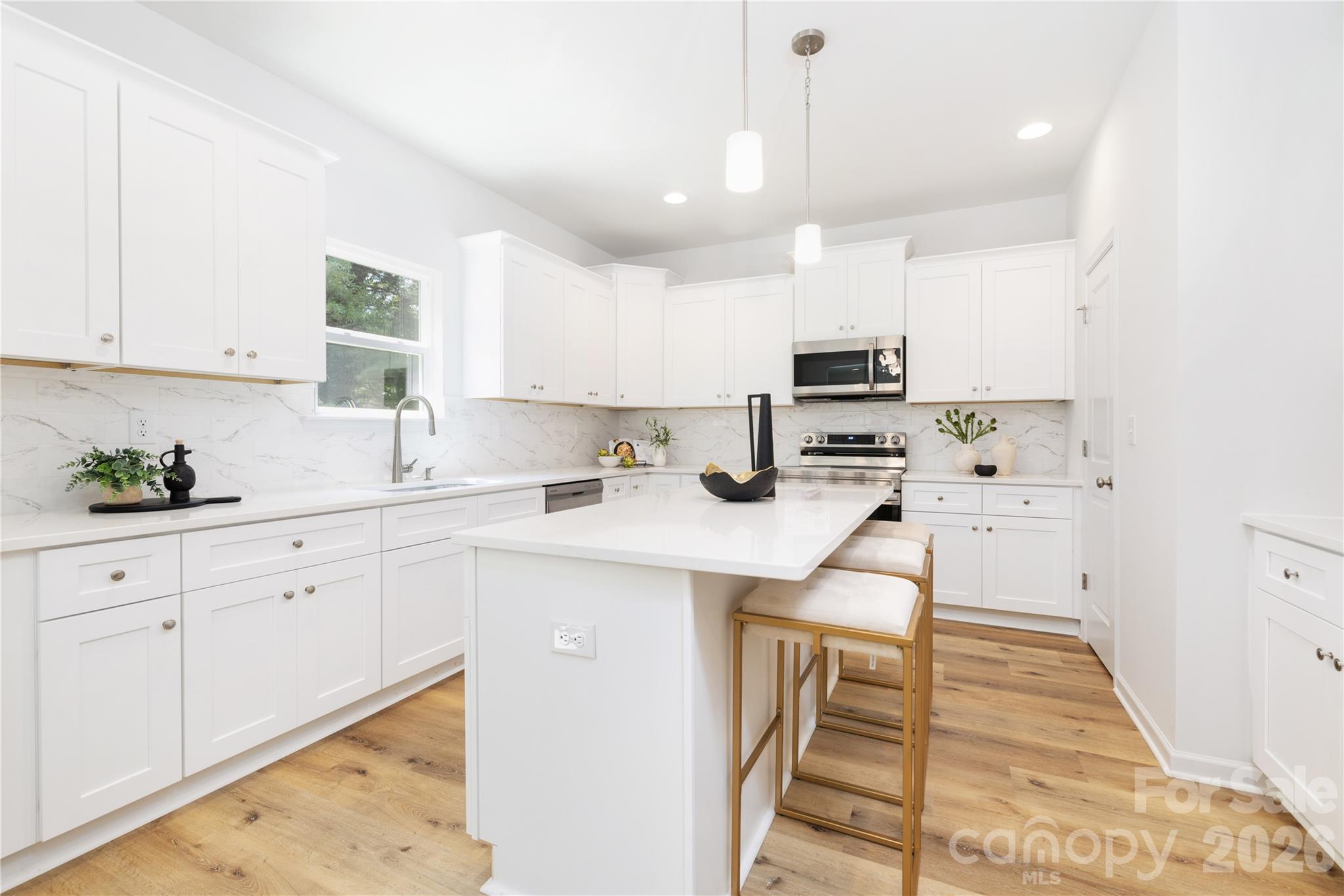 10606 Arlington Church Road Mint Hill, NC 28227 - Photo 11 of 26 a kitchen with white cabinets and sink
