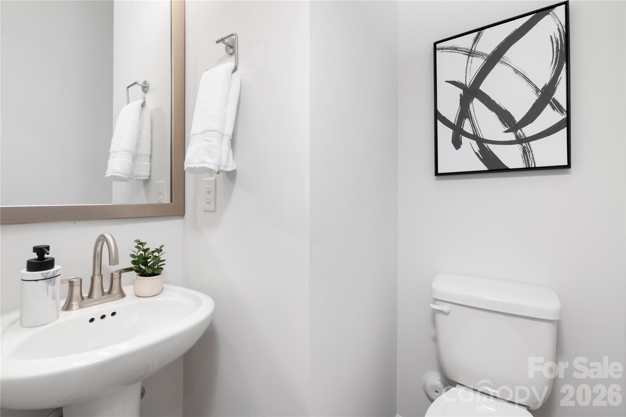 10606 Arlington Church Road Mint Hill, NC 28227 - Photo 5 of 26 a bathroom with a toilet sink and mirror