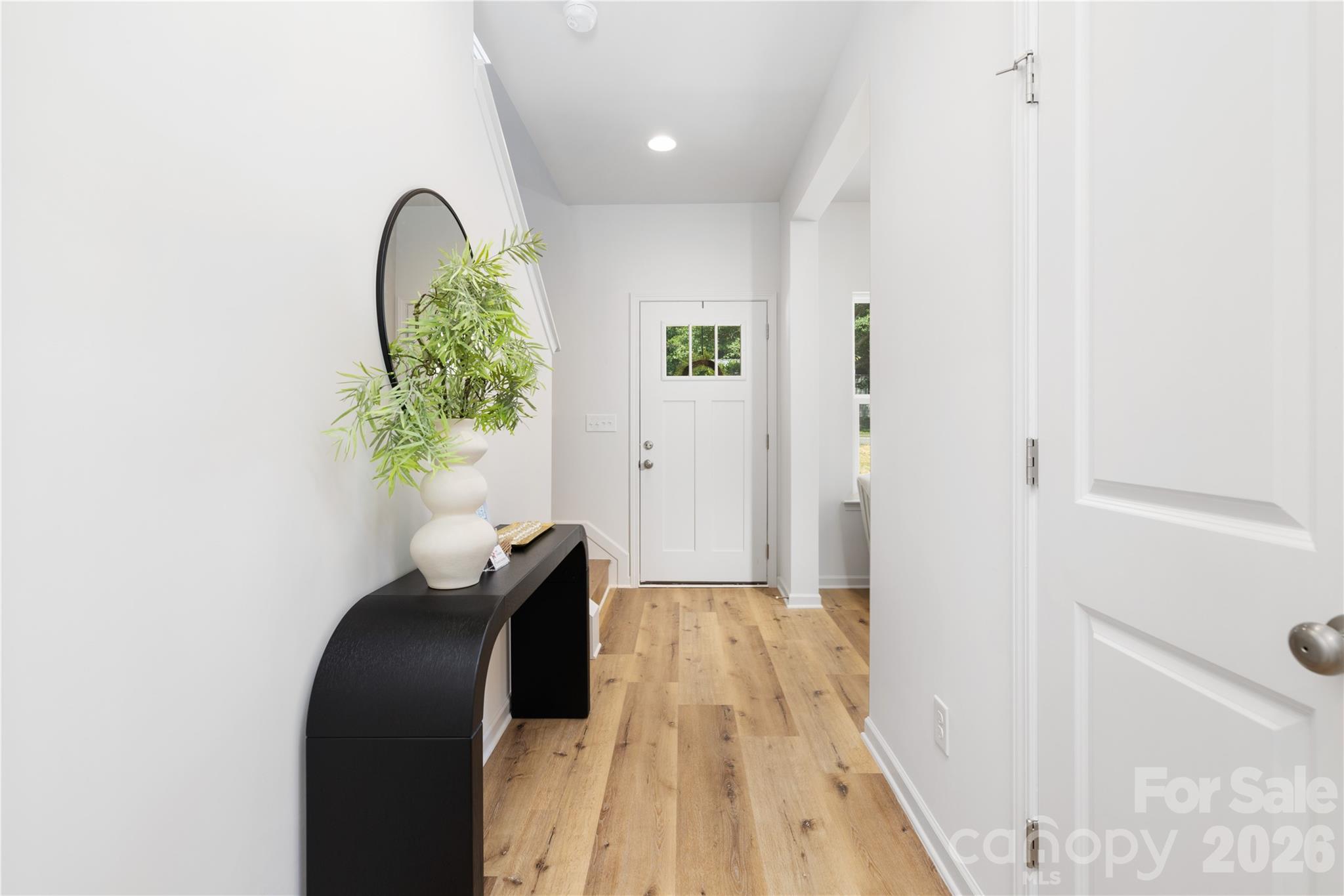 10606 Arlington Church Road Mint Hill, NC 28227 - Photo 6 of 26 a view of a hallway with wooden floor
