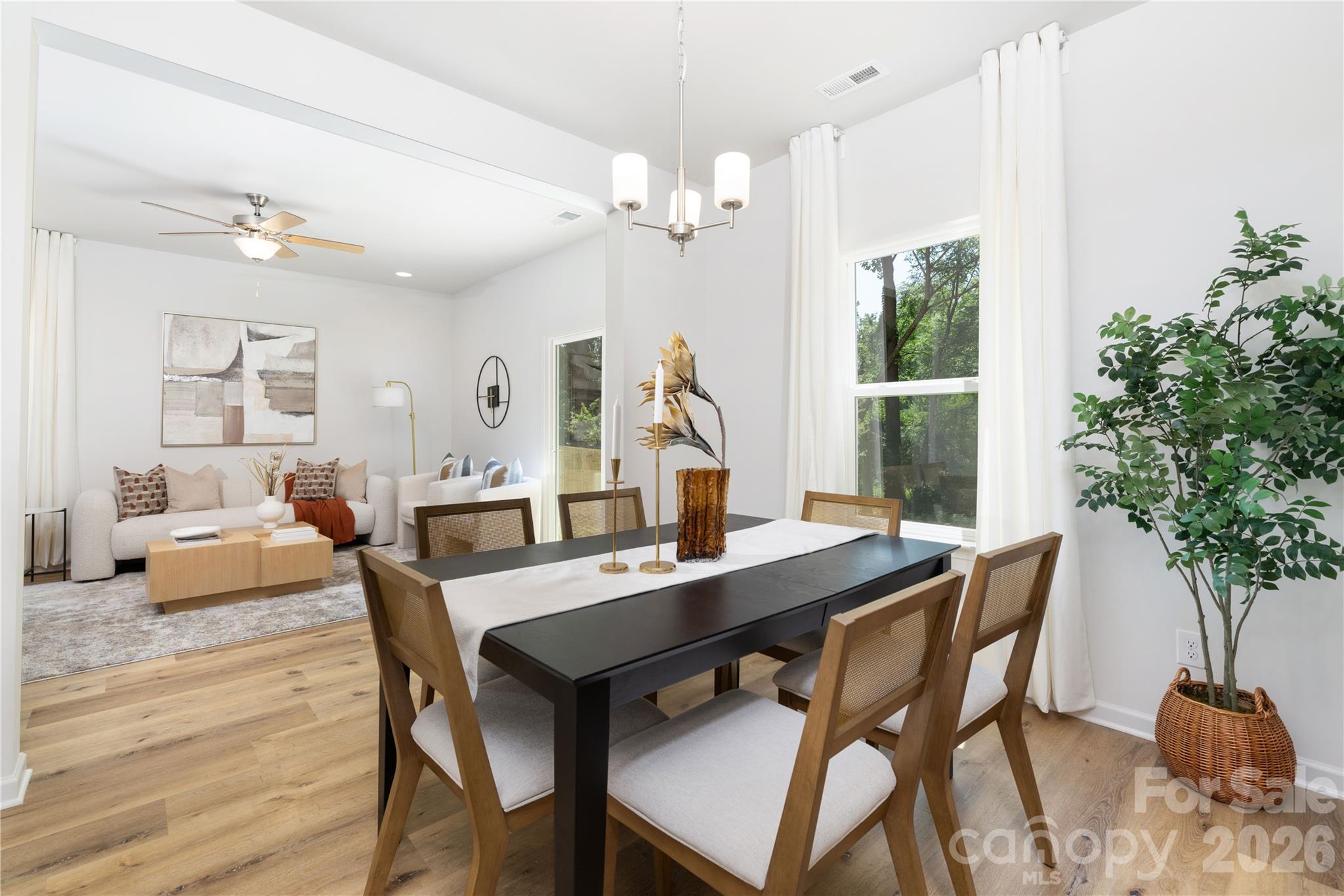10606 Arlington Church Road Mint Hill, NC 28227 - Photo 10 of 26 a view of a dining room with furniture window and wooden floor