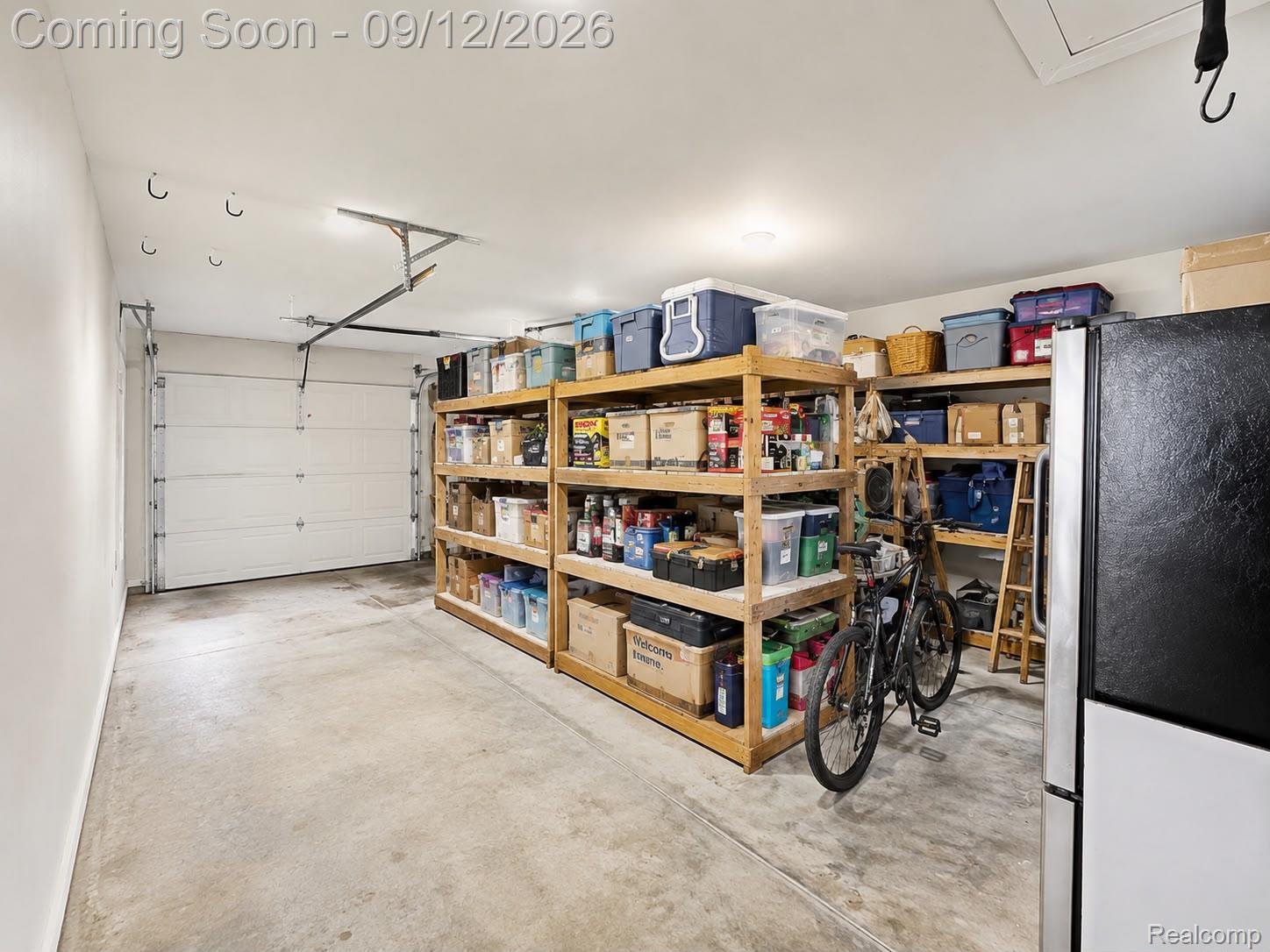 34398 Greentrees Road Sterling Heights, MI 48312 - Photo 30 of 36 Garage space featuring a paneled overhead door and concrete flooring