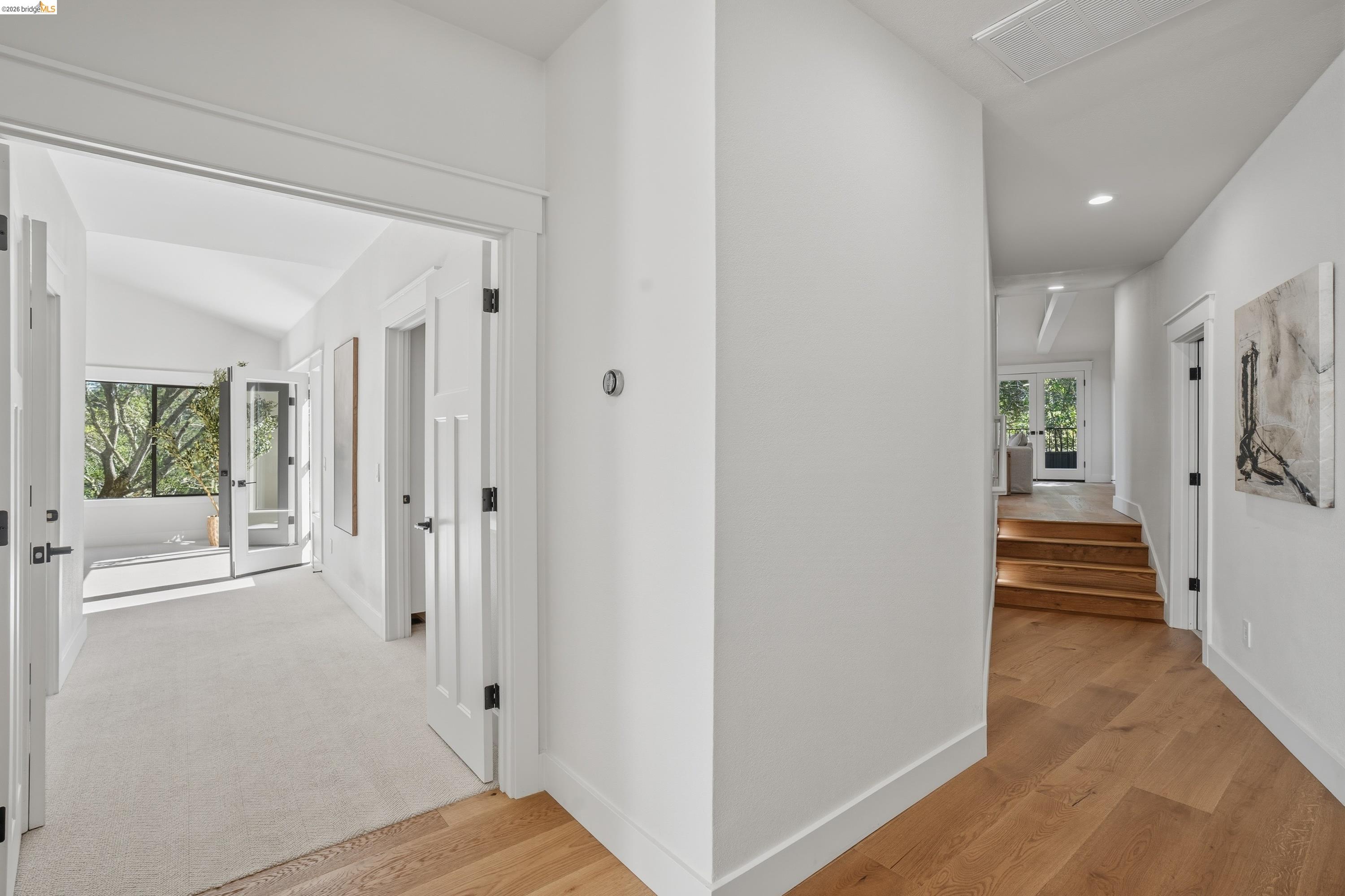 4120 Happy Valley Road Lafayette, CA 94549 - Photo 39 of 48 Interior hallway featuring wood-finish flooring, white paneled doors with matte black hardware, and recessed lighting