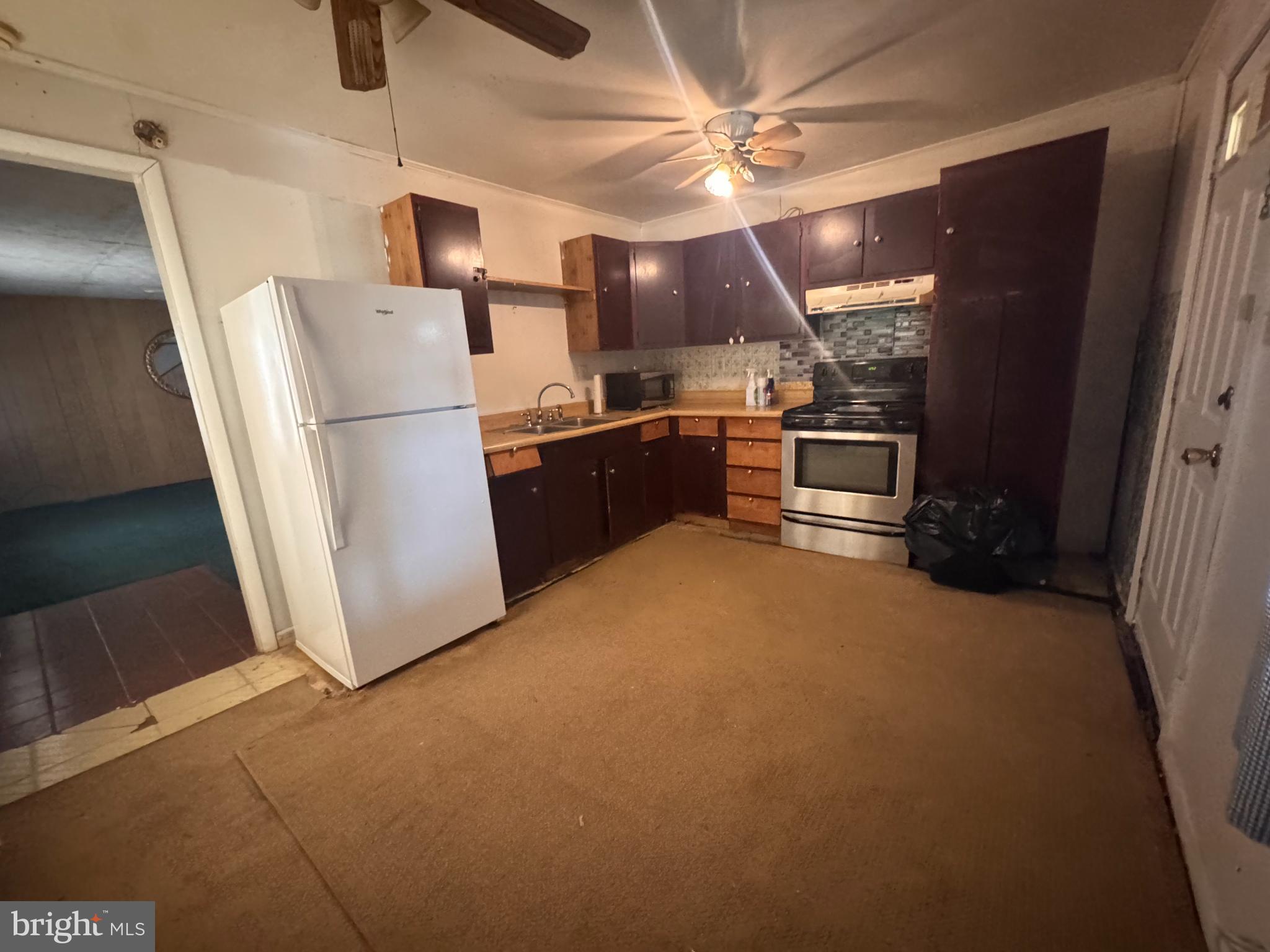 20436 Bowles Road Coltons Point, MD 20626 - Photo 6 of 14 a kitchen with refrigerator and cabinets