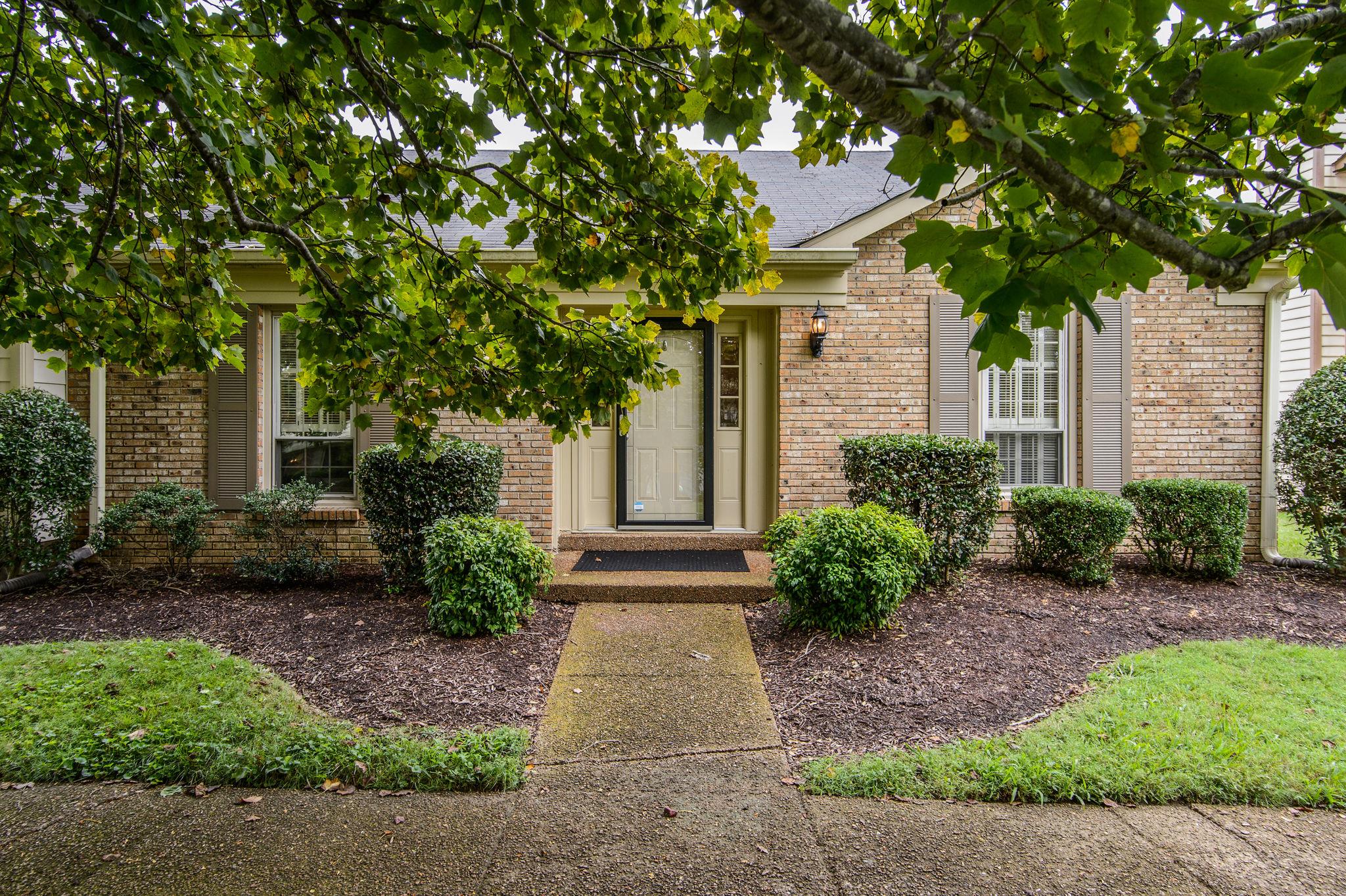 949 General George Patton Road Nashville, TN 37221 - Photo 1 of 25 a front view of a house with garden