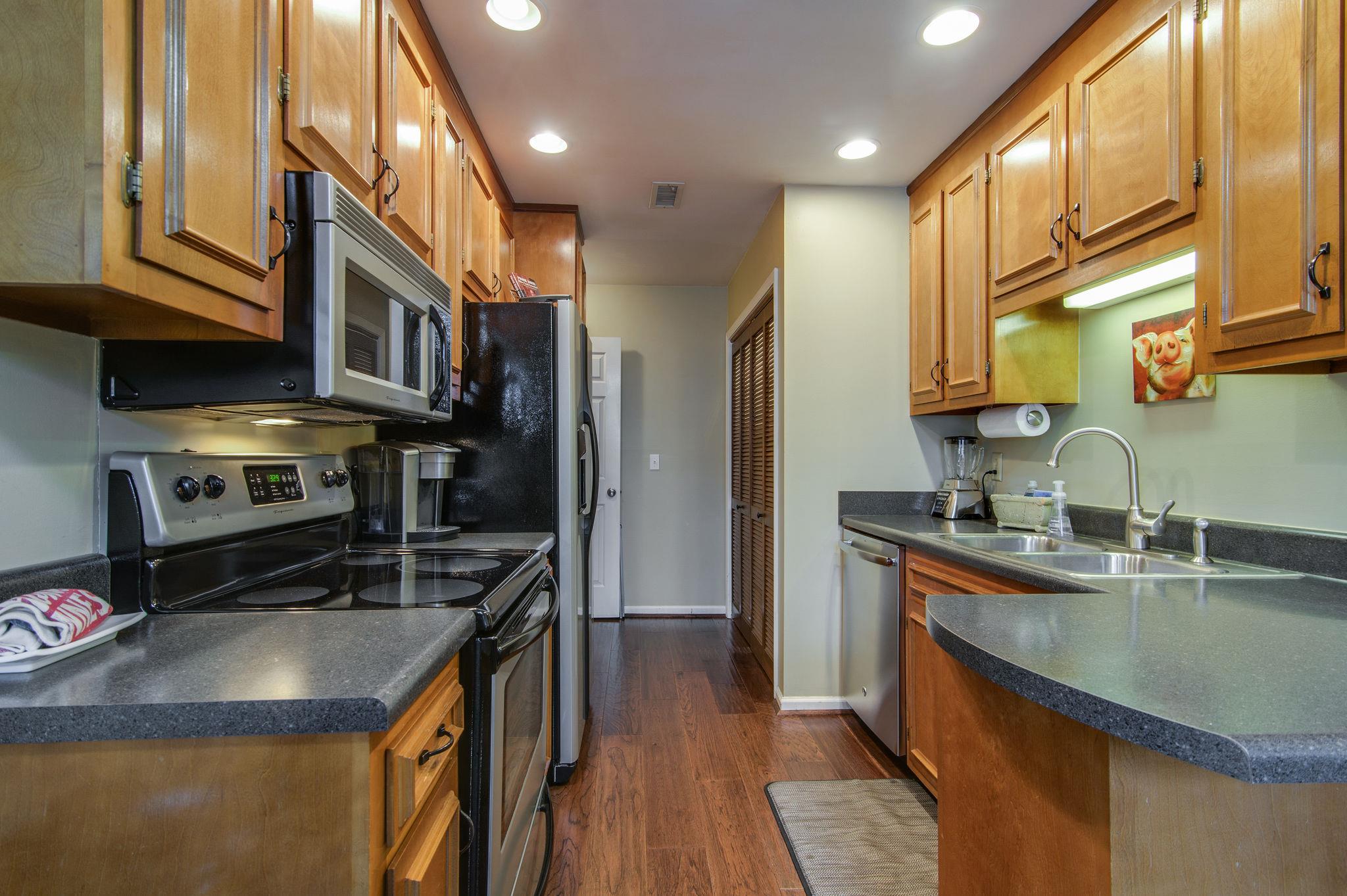 949 General George Patton Road Nashville, TN 37221 - Photo 14 of 25 a kitchen with stainless steel appliances granite countertop a sink a stove and a refrigerator