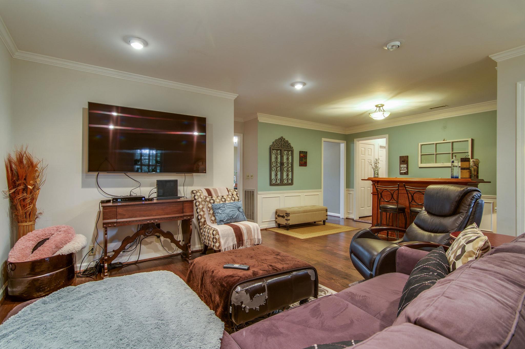 949 General George Patton Road Nashville, TN 37221 - Photo 8 of 25 a living room with furniture and a flat screen tv