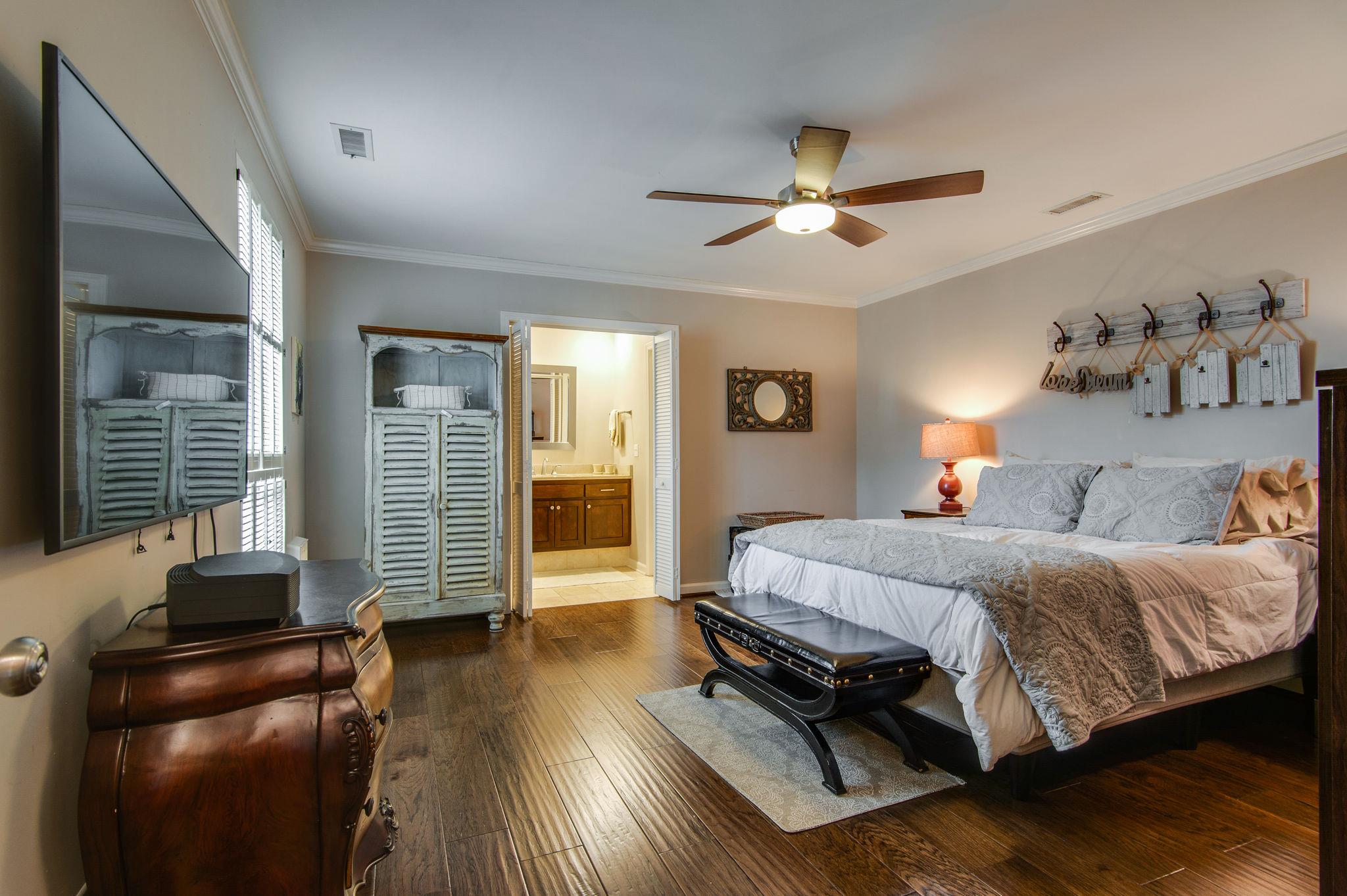949 General George Patton Road Nashville, TN 37221 - Photo 10 of 25 a spacious bedroom with a bed and wooden floor
