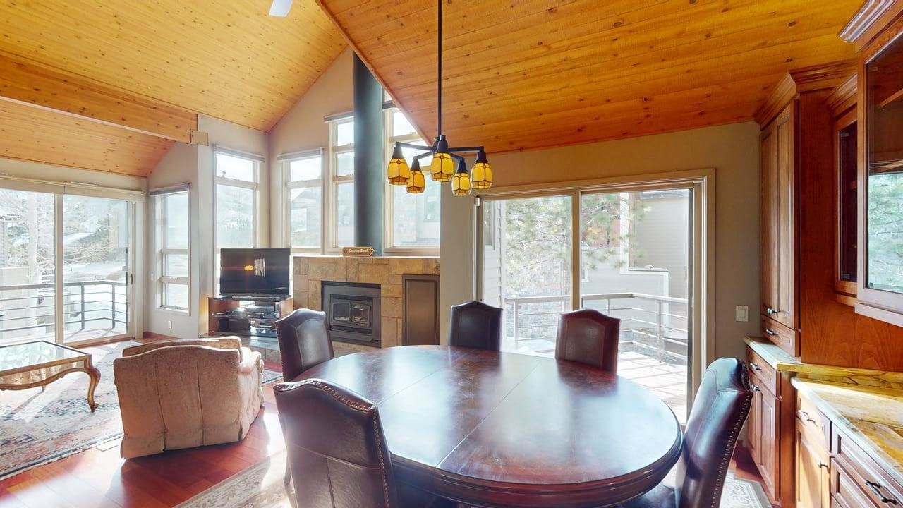 3600 Chateau Road, Unit 2 Mammoth Lakes, CA 93546 - Photo 5 of 27 Dining space featuring a wood stove, light wood-type flooring, wooden ceiling, and a chandelier