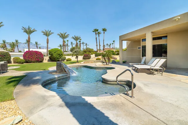 a view of swimming pool with a patio and ocean view