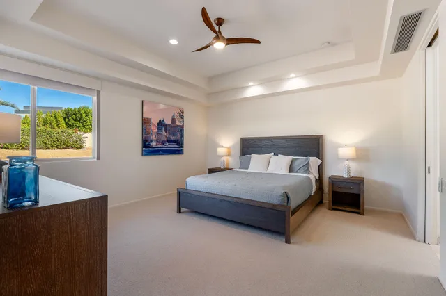 a bedroom with a large bed and a couch